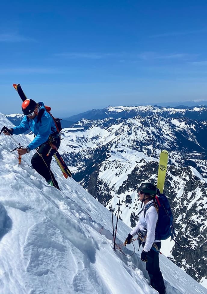 Two people ski mountaineering